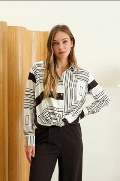 Experience modern sophistication in our Geo Print Collared Blouse. The black and white geometric pattern adds a bold touch to any outfit, while the collared neckline adds a touch of elegance. Make a statement and stand out in style with this unique top. Product Details: RUNS SMALL (if in between sizes, size up) COLLARED LONG SLEEVES BUTTON DOWN TWIST FRONT DETAIL GEO PRINT 95%POLYESTER 5%SPANDEX Black And White Geometric Pattern, Wrangler Accessories, Night Style, Collared Blouse, Romper And Jacket, Unique Top, Skirt Jumpsuit, Black Trousers, Top Graphic Tees