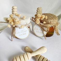 two jars filled with honey sitting on top of a table