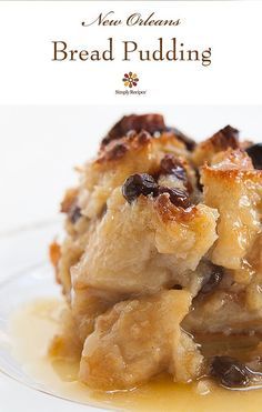 bread pudding with raisins and olives is on a clear glass plate that says new orleans bread pudding