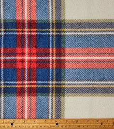 a plaid fabric with red, white and blue colors is shown next to a ruler