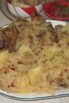 a white plate topped with potatoes and meat