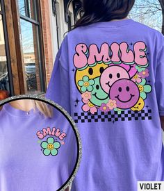 Our retro smiley face graphic tee features a front and back vintage inspired Summer print happy face collage design. Our crewneck pairs perfectly with other matching size and style variations (linked below). ✩ ✩ 𝗞𝗶𝗱𝘀 𝗖𝗼𝗺𝗳𝗼𝗿𝘁 𝗖𝗼𝗹𝗼𝗿𝘀 𝗧𝗲𝗲: https://starrieapparel.etsy.com/listing/1752201430 ✩ 𝗔𝗱𝘂𝗹𝘁 𝗖𝗼𝗺𝗳𝗼𝗿𝘁 𝗖𝗼𝗹𝗼𝗿𝘀 𝗧𝗲𝗲: https://starrieapparel.etsy.com/listing/1765970391 Smiley Face Shirt, Flower Shirt, Retro Smile Face, Trendy Vintage Graphic Tee, Checkered Com Cheap Fun Smiley Face T-shirt, Smiley Face Graphic, Retro Smiley Face, Face Collage, Smiley Face Shirt, Yellow Smiley Face, Face Graphic, Clothing Design Sketches, Club Ideas