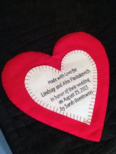 a heart shaped pillow with a poem written on the front and back in red, white and black