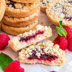 some cookies and raspberries on a table