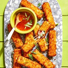 fried fish sticks with dipping sauce on a plate