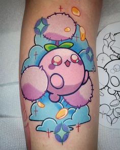 a cartoon character tattoo on the leg of a woman's leg, with clouds and stars around it