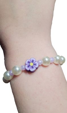 a bracelet with flowers and pearls on it