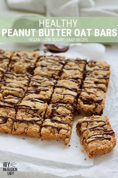 healthy peanut butter oat bars with chocolate drizzled on top, cut into squares