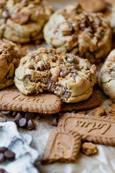 cookies and chocolate chips are arranged on top of each other, with one cookie broken in half