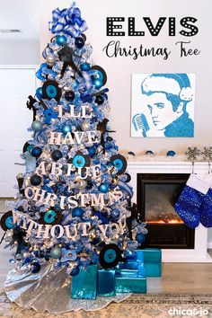 a christmas tree decorated with blue and silver ornaments in the shape of elvis presley's name