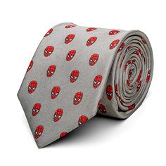 a gray tie with red spiderman heads on it's side and a white background