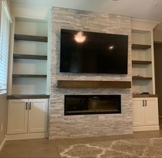 a large flat screen tv mounted above a fireplace