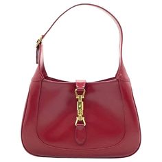 Gucci Jackie 1961 Burgundy Red Leather Bag Small with Adjustable Strap The Gucci Jackie 1961 Red Handbag is a modern take on an iconic design. Crafted in leather with a structured silhouette, it features a crossbody strap so you can bring your essentials wherever life takes you. The red is Gucci's color of the season in 2024. Condition: NEVER WORN DETAILS: Brand: Gucci Model: Jackie 1961 Exterior Color: Red or Burgundy Exterior Material: Leather Interior Material: Suede Interior Color: Beige Hardware Color: Gold Size: small. The middle of all three sizes. Most versatile and practical. Dimensions: Width: 28cm, Height: 18.5 ACCESSORY: Adjustable long strap, dust bag, box Gucci Jackie Red, Jackie Gucci Bag, Gucci Red Bag, Red Gucci Bag, Gucci Jackie 1961, Burgundy Bag, Red Leather Bag, Hermes Kelly Bag, Gucci Outfits