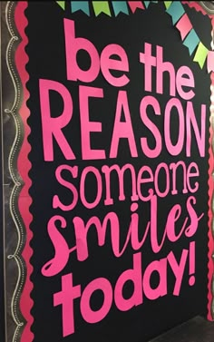 a sign that says be the reason someone smiles today