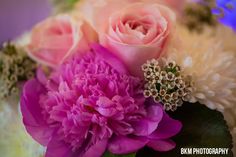 pink and white flowers are in a vase