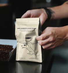 a bag of coffee sitting on top of a table next to a bowl of beans