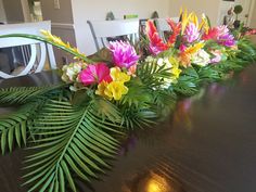 a table with flowers and leaves on it