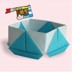 an origami box is shown on a pink background