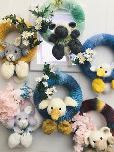 several knitted wreaths with stuffed animals and flowers