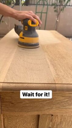 a person using a sander on top of a wooden table with the words wait for it