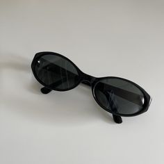 These round oval sunglasses are your everyday classic. Featuring a black frame with black smoke lens. This style is unisex. True genuine vintage sunglasses from the 90s.  - 400 uv  - new vintage from the 90s - includes sunglasses pouch  Measurements: Lens width 58mm Lens height 34mm Frame width 133mm Bridge 17mm Arm temple 130mm Available in other colors Red tortoise https://etsy.me/3mgHuDR Amber red https://etsy.me/3FIQCZU Trendy Oval Sunglasses, Amber Sunglasses, Black Oval Sunglasses, 90s Sunglasses, Sunglasses Pouch, Y2k Sunglasses, Chic Sunglasses, Oval Sunglasses, Vintage Sunglasses