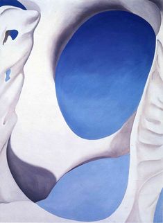 an abstract painting with blue and white colors on the walls, including two large circular shapes