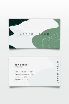 two white and green business cards sitting on top of each other