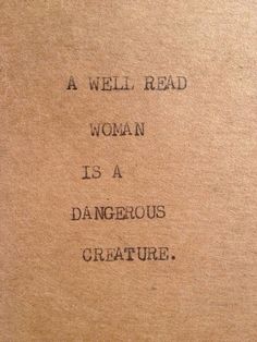 a well read woman is a dangerous creature written on a piece of brown paper with black ink