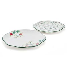 two white and green plates with flowers on them