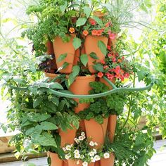 a tall tower of pots filled with plants