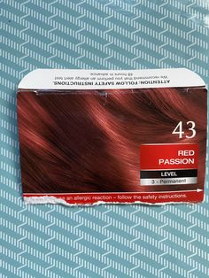 a box of red hair sitting on top of a table