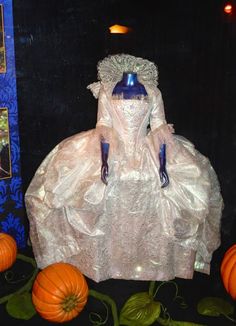 there is a dress and pumpkins on display