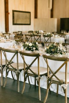 the tables are set with white tablecloths and silverware for an elegant wedding reception