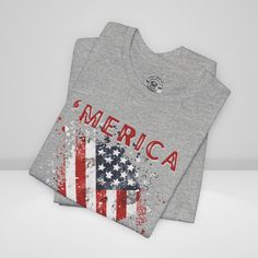 Show your unwavering support with our American Patriot T-shirt! This tee proudly features a grunge style American Flag with the bold statement ''Merica' making this T-shirt a stylish choice for a true American patriot. Product details This classic unisex jersey short sleeve tee fits like a well-loved favorite. Soft cotton and quality print make users fall in love with it over and over again. These t-shirts have-ribbed knit collars to bolster shaping. The shoulders are tapered for a better fit over time. Dual side seams hold the garment's shape for longer. >Bella Canvas 3001 TShirt >This t-shirt comes with a lightweight fabric (4.2 oz/yd² (142 g/m²)) >The tear-away label minimizes skin irritations and provides a scratch-free wearing experience. >Fabric blends: Ash - 99% Airlume combed and r Memorial Day Crew Neck T-shirt Made In Usa, Memorial Day American Flag Print Top For Streetwear, Memorial Day American Flag Print Tops For Streetwear, American Flag Print Tops For Memorial Day Streetwear, American Flag Graphic Tee With Crew Neck, American Flag Cotton T-shirt For Streetwear, Memorial Day Graphic Tee Made In Usa, Made In Usa Tri-blend Graphic Tee, Usa Made Tri-blend Graphic Tee