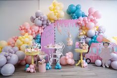 a birthday party with balloons, cake and decorations