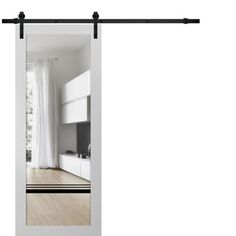 an open sliding door with white curtains in the background