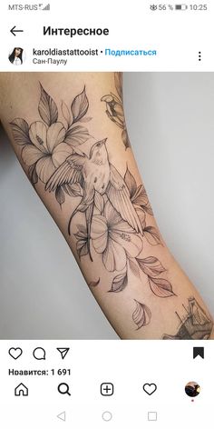 a woman's arm with flowers and birds on it, in black and white