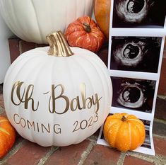 a white pumpkin with the words oh baby coming next to other pumpkins and photos