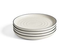 four white plates stacked on top of each other in front of a white background,