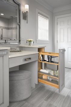 an open cabinet in the corner of a bathroom