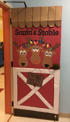 the door to santa's stable is decorated with paper