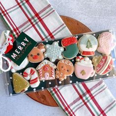 decorated christmas cookies in a box on a table