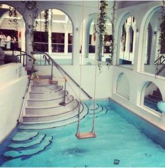 an indoor swimming pool with steps leading up to it