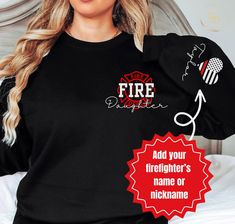 a woman wearing a firefighter's name ornament on her black shirt