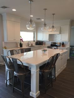 a large kitchen with an island in the middle