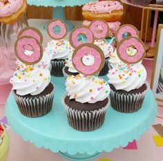 there are cupcakes with pink frosting and numbers on them