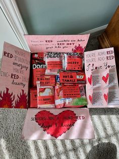 valentine's day gifts are arranged in a heart - shaped box on the floor