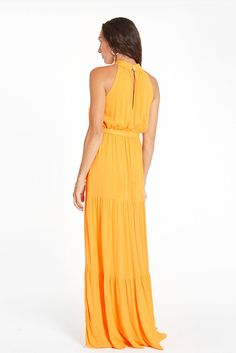 Feel the wind in your hair and the sand between your toes. This luxurious, beautiful mango-colored maxi dress is perfect for any occasion. Made from a high-quality, silky soft fabric and elastic at the waist, not only will you be looking elegant and chic, but you won’t have to give up comfort with our Gia dress. You'll be sure to turn heads whenever you're wearing it! Responsibly handmade in Bali with all the love. Ethically handcrafted from luxurious sustainable fabrics certified Oeko Tex Standard 100.SustainabilitySustainable materialsResponsible manufacturingSmall batch handmadeLess pollutionLess waste1% For The Planet MemberHow It FitsFits true to sizeSizeHeight 5'7", Waist 25", Bust 34C, Hips 35.5"Model Wearing a size SmallProduct Details Maxi length Halter neckline Real shell button Gia Dress, Sustainable Clothing Brands, Different Outfits, Sustainable Fabrics, Sustainable Clothing, The Sand, Ethical Fashion, Feminine Style, Slow Fashion