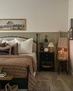 a bedroom with a bed, night stand and two lamps on either side of the bed