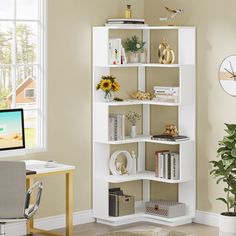 a white book shelf in the corner of a room next to a desk and chair